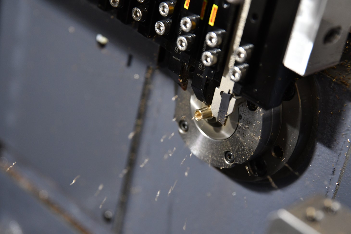 Inside of a CNC machine in action, cutting a brass part