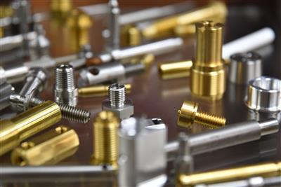 Various turned metal parts displaying different materials and specifications